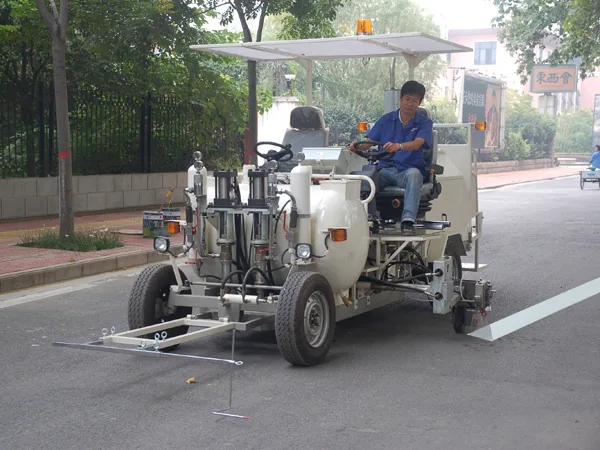 Operator using a road line-marking machine